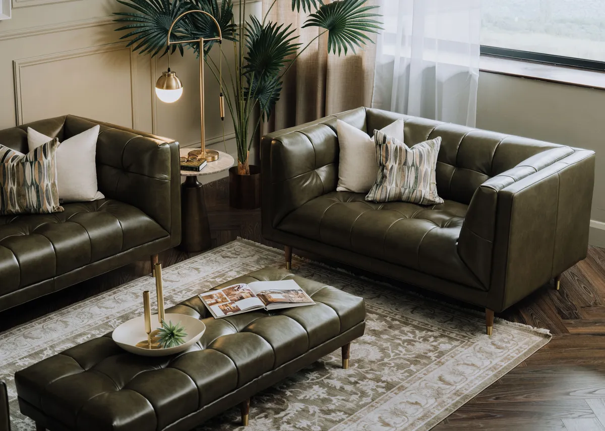 A lifestyle image of the Grace green leather sofa with pyramid side tabe and Casper lamps with Arden rug.