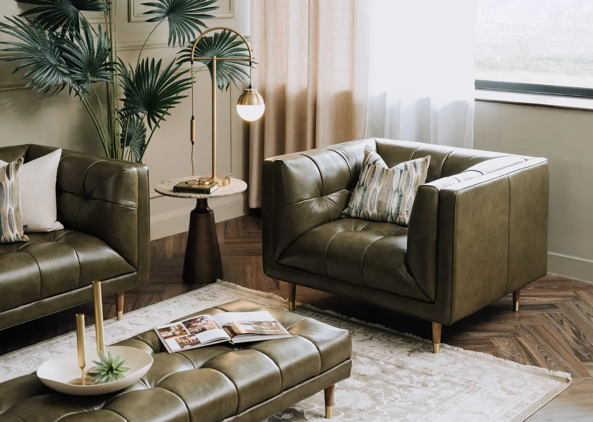 A lifestyle image of the Grace armchair with footstool with Pyramid side table with Casper lamp.