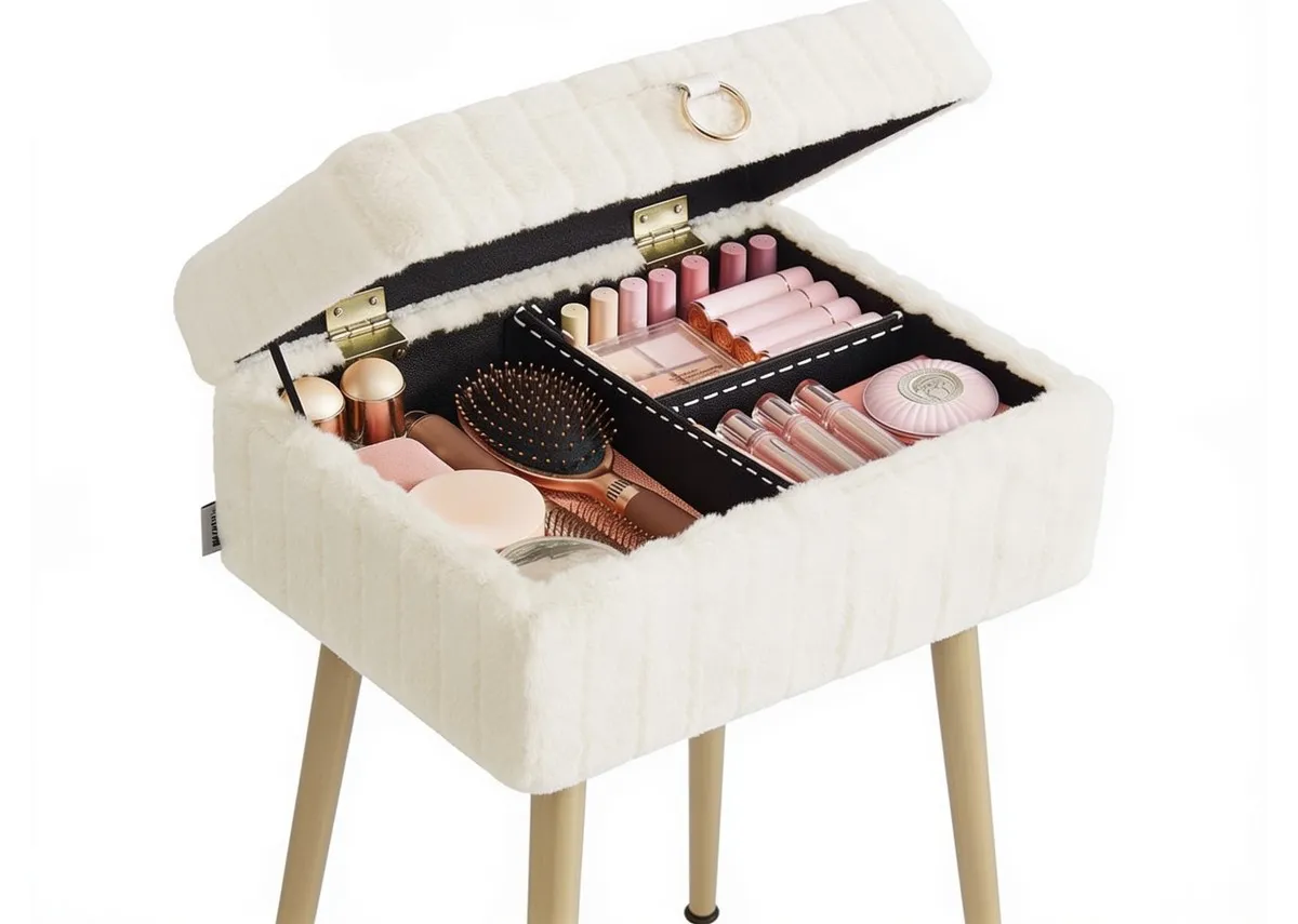 A cream fabric covered stool with wood legs from EZ Livings Sophia range. Angled view of top opened showing makeup and skin care storage