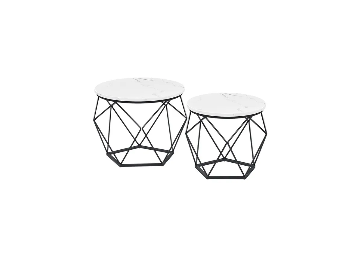 A set of 2 hexagonal black metal tables with white tops. Angled view of tables with removable tops for storage.