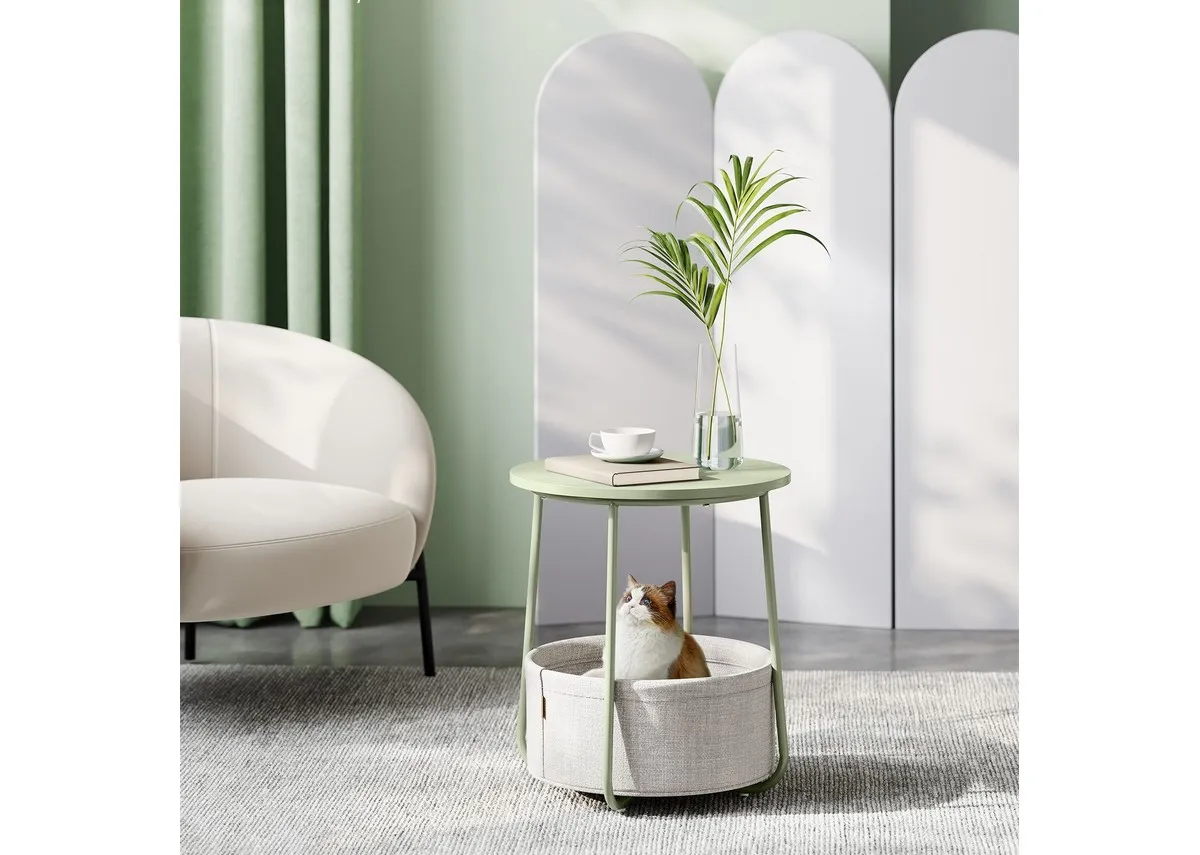A green metal side table with lower basket from EZ Livings Olive range.Closeup of basket