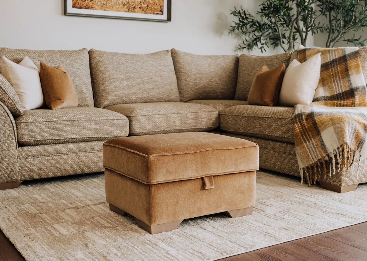 A lifestyle image of the Strata footstool with the corner chaise and Drift rug.