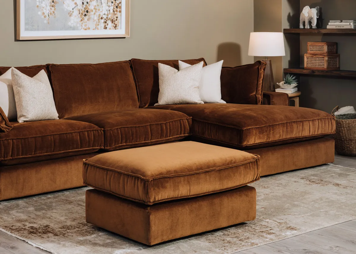 A lifestyle image of the Addison chaise with footstool and the Woodland warmth canvas with Drift rug.