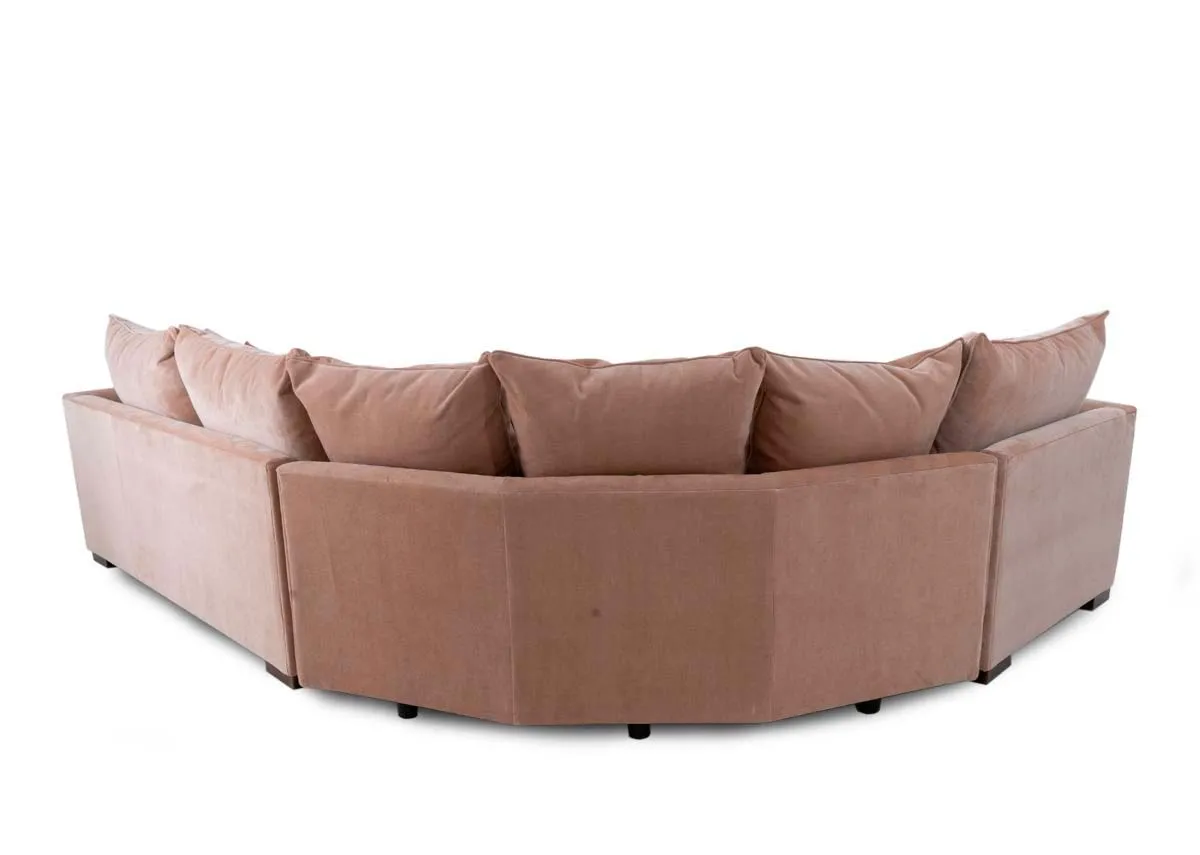 An RAF pink fabric corner sofa with rust cushions from Lucius range. Back view of warrantied frame