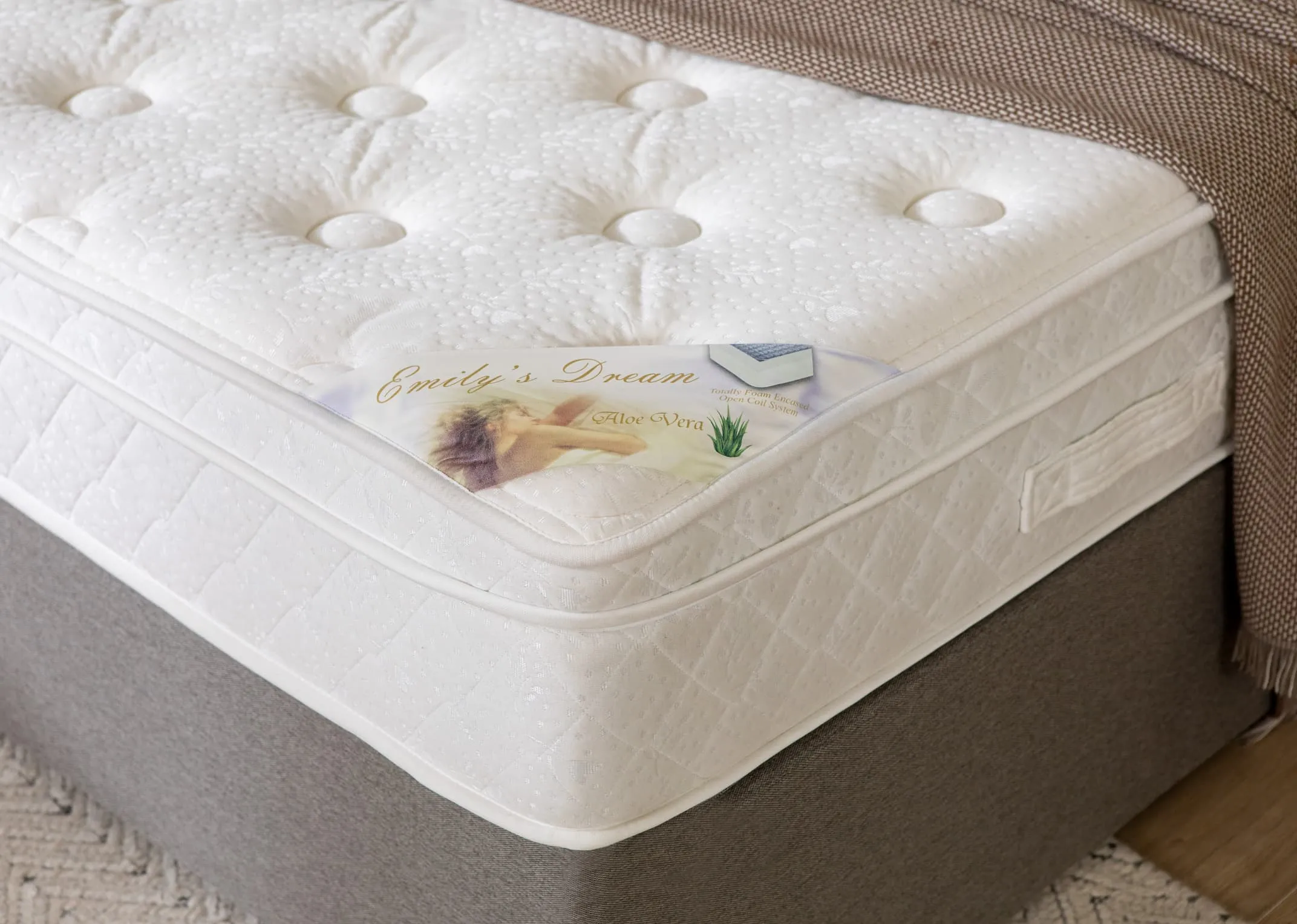 A lifestyle image of the Emilys dream mattress on a Modena bed base with closeup detail on mattress