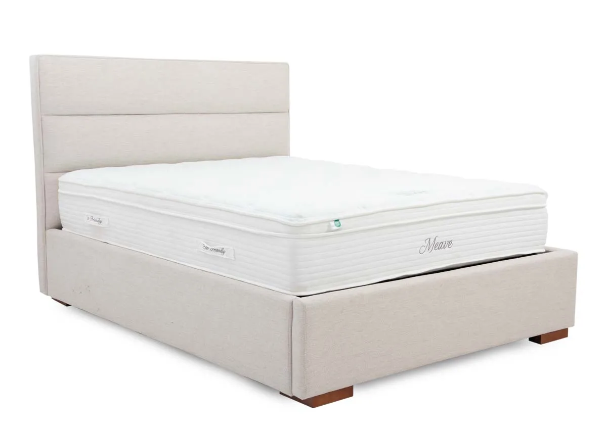 A beige fabric ottoman bed with mattress from EZ Livings Ebony range. Angled view.