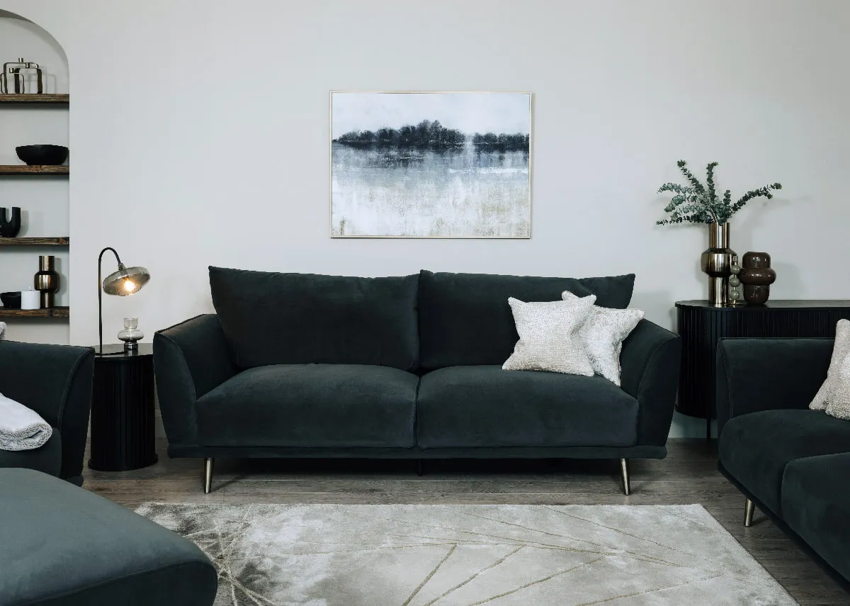 A lifestyle image of the Katie 4 seater with nola black side table with camila table lamp.