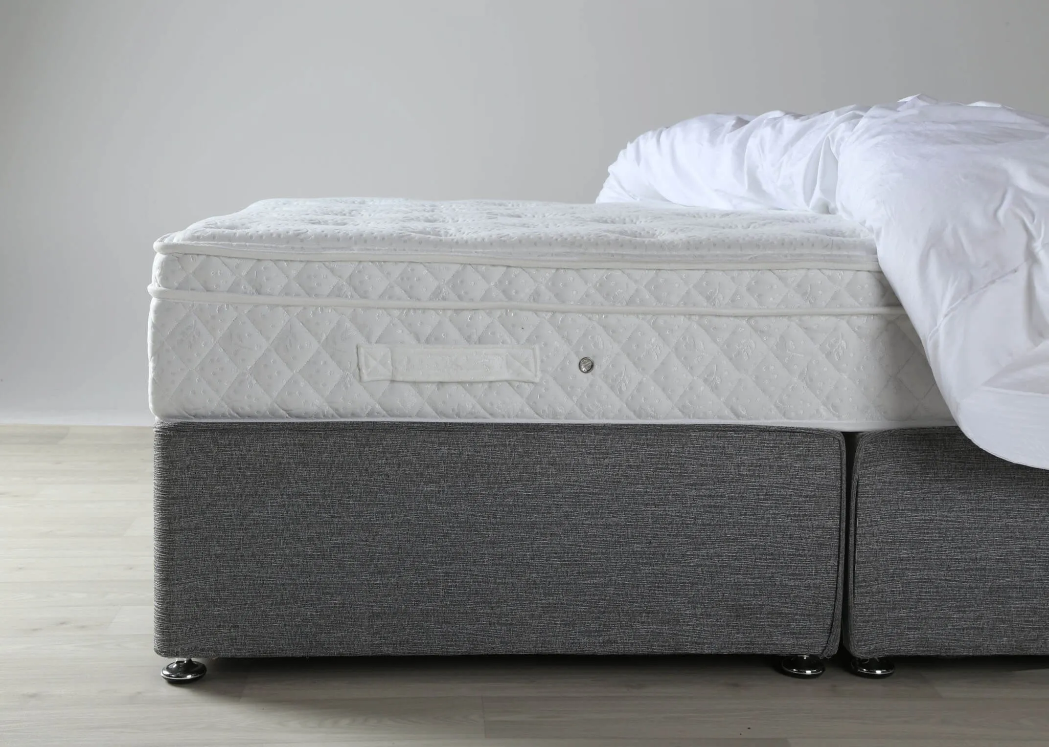 A lifestyle image of the Emilys Dream 3 foot mattress shown on a bed with duvet.