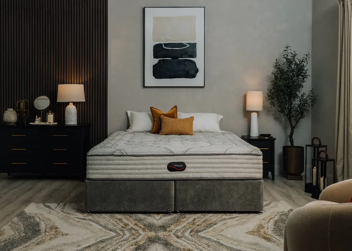 A lifestyle image of the Elite Comfort mattress with black chevron locker and chest from EZ Living.