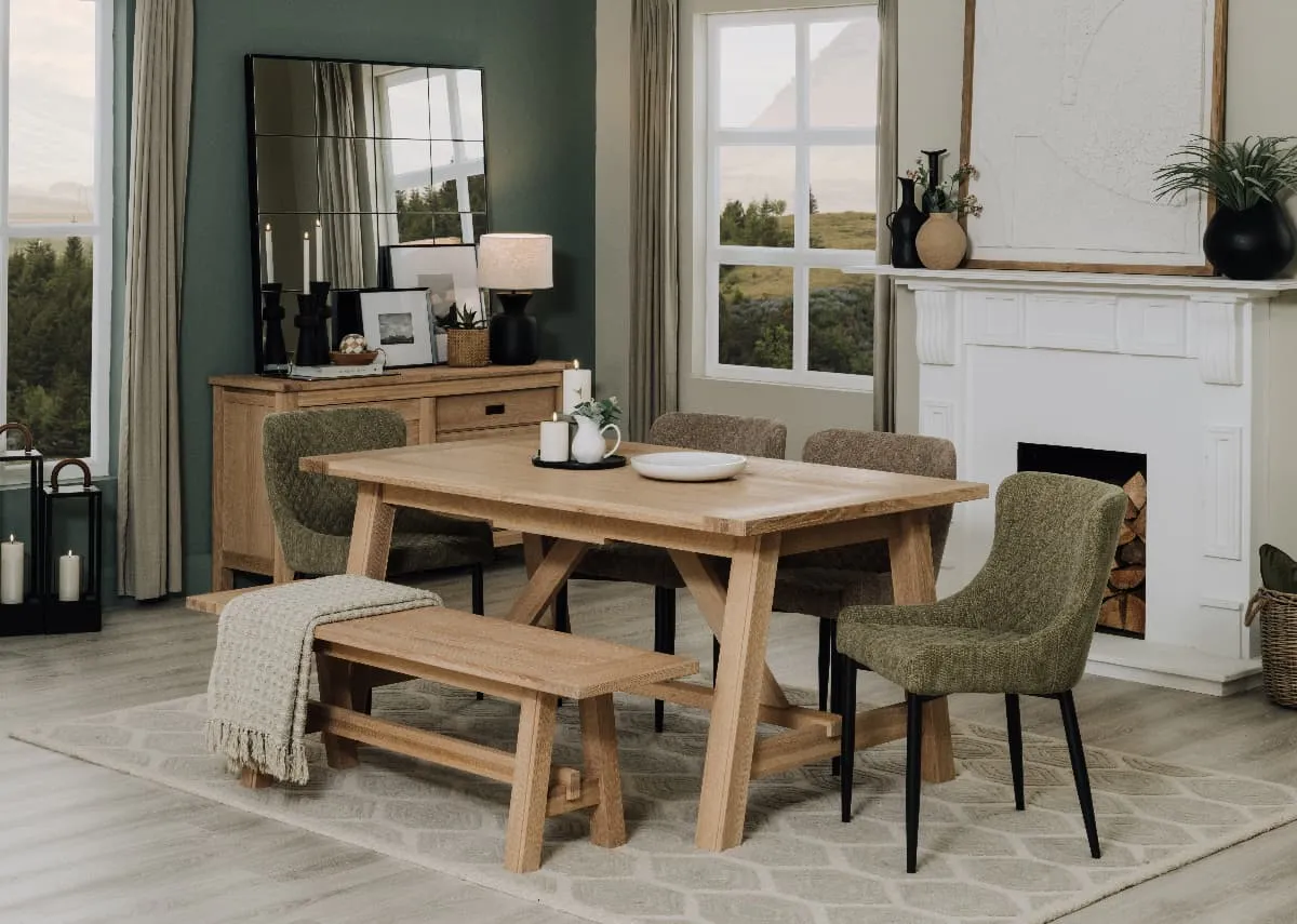 A lifestyle image of the Albany dining table extended & bench with Dylan chairs in green and Albany sideboard.