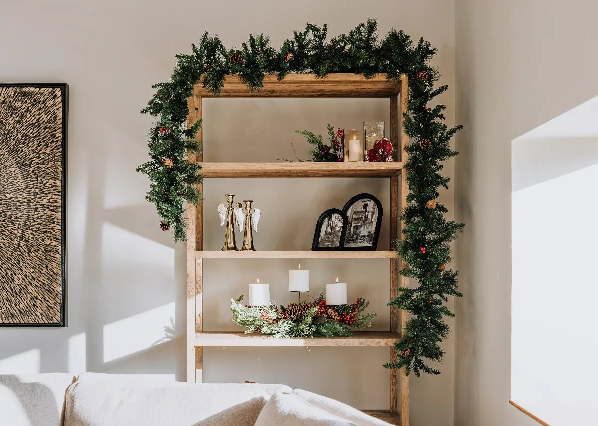 A lifestyle image of the Nova bookcase with green garland with lights