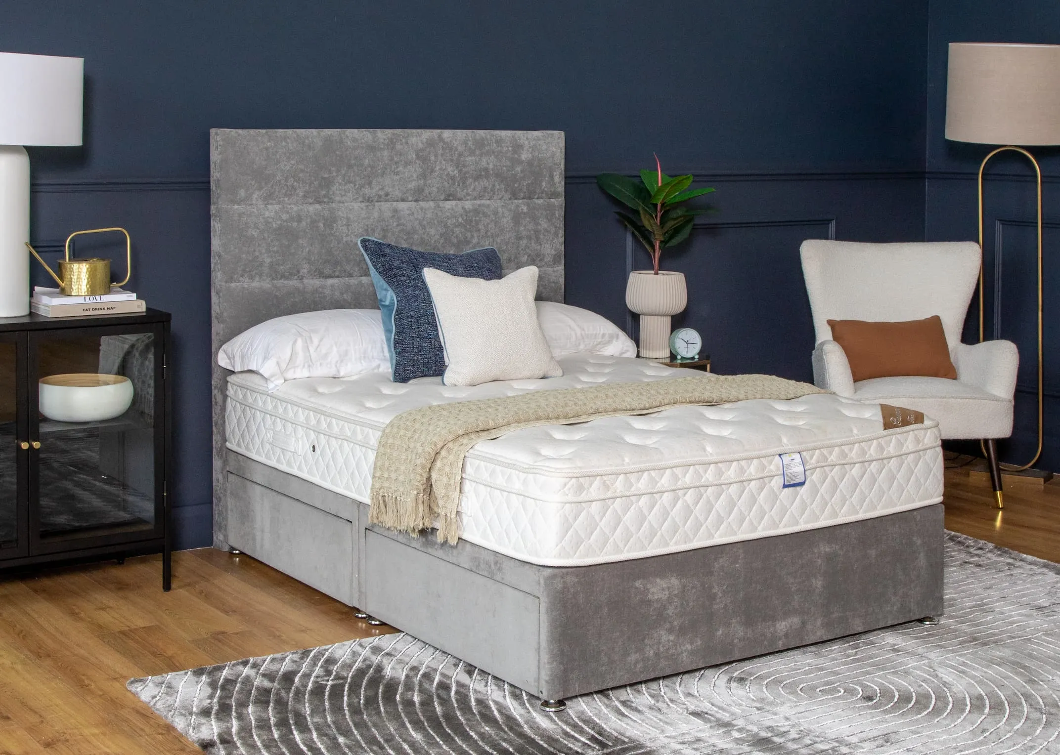 A lifestyle image of the Majesty Cashmere Mattress on the Venice divan with Shiraz Occasional chair & Okno floor lamp.