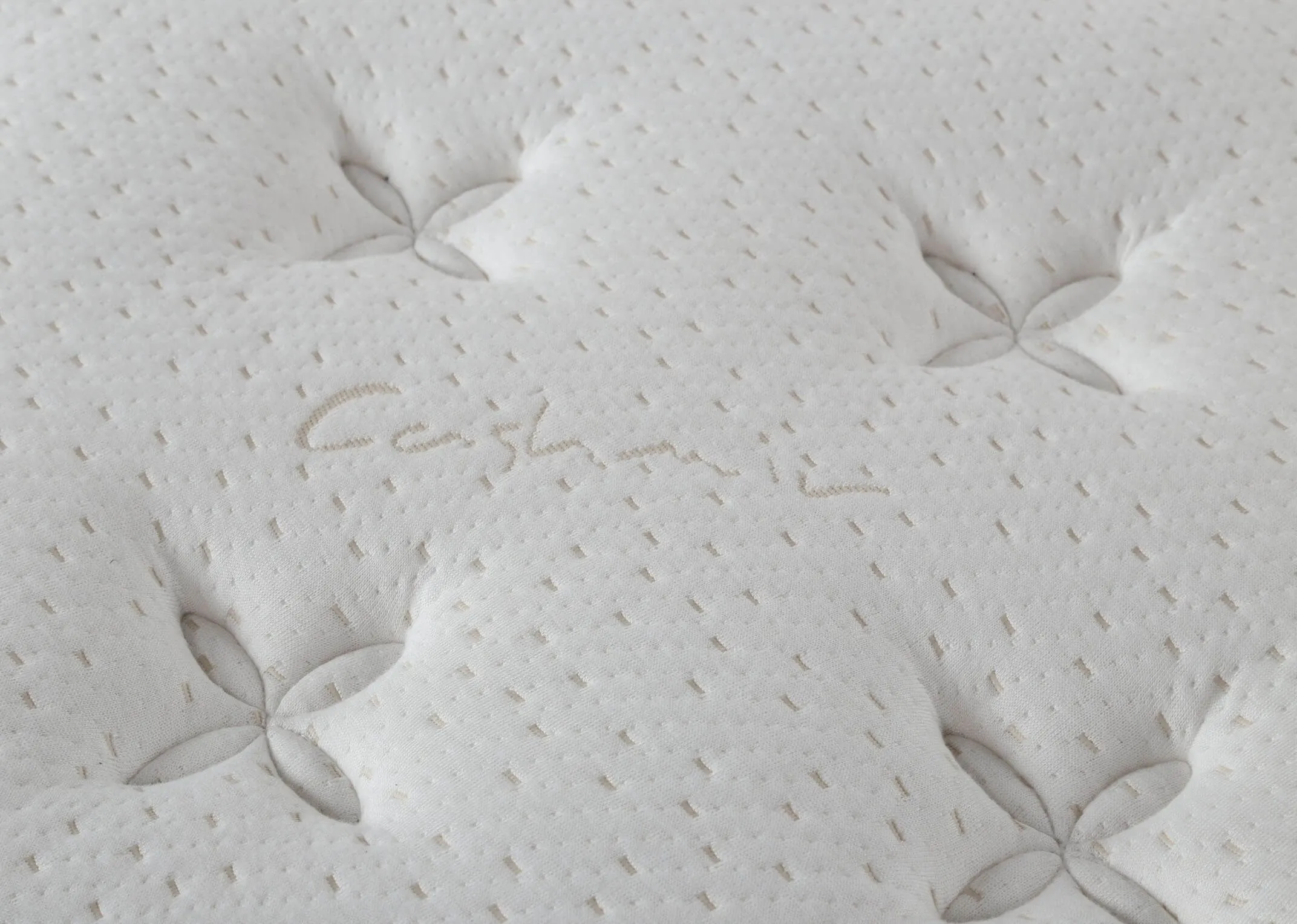 A view from the side of the Majesty Cashmere 5 foot king size mattress on a bed frame.