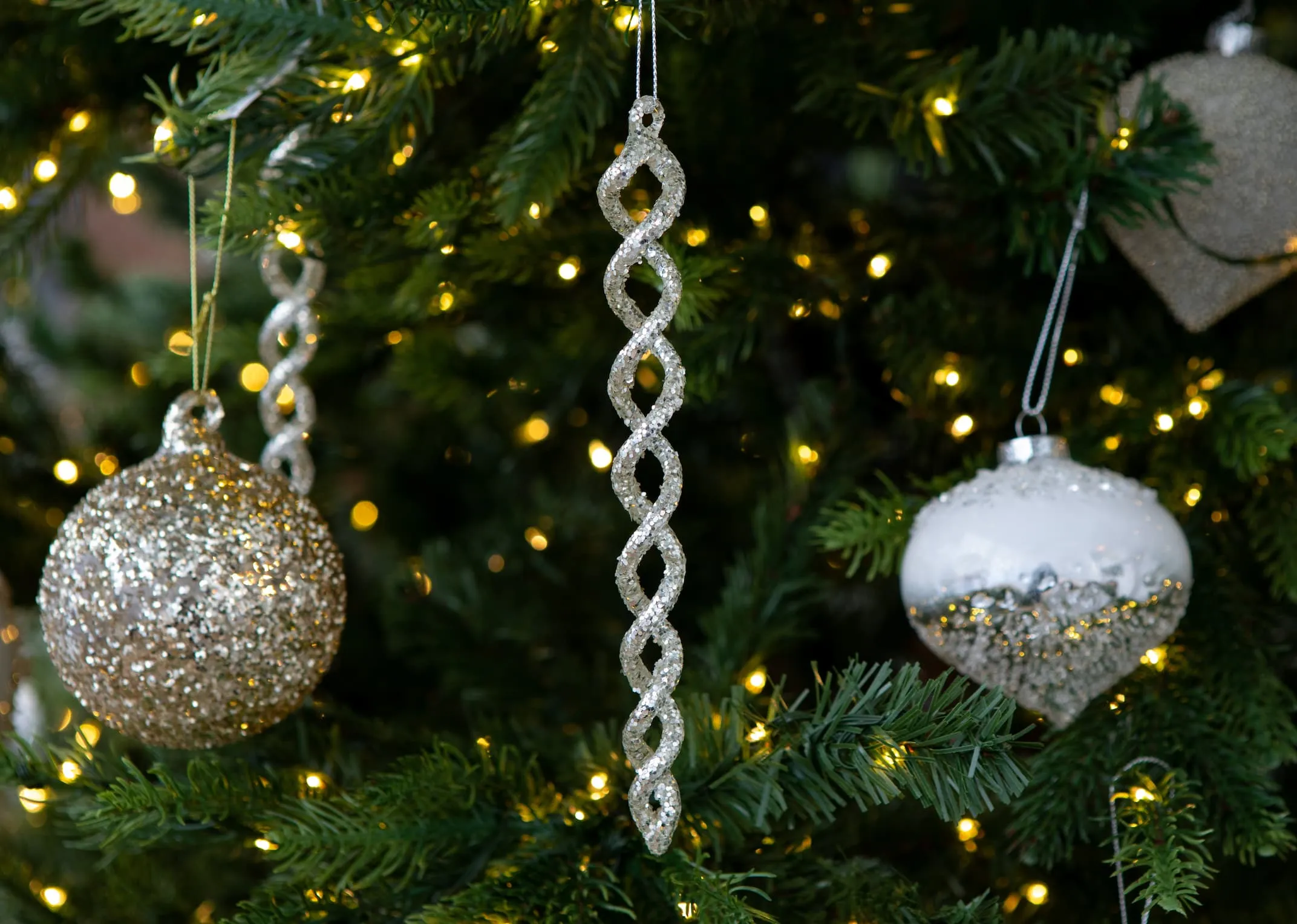 A lifestyle image of the Icicle Ornament hanging on the Vermont tree