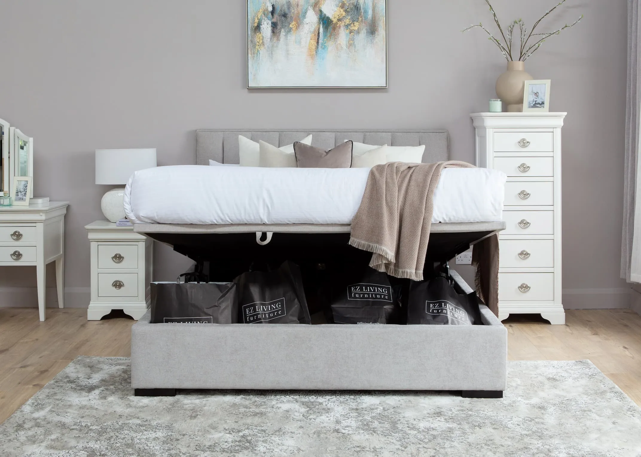 A light grey fabric 4ft6 ottoman bed frame from EZ Living Furniture's Liberty range. End view shows headboard/solid base.
