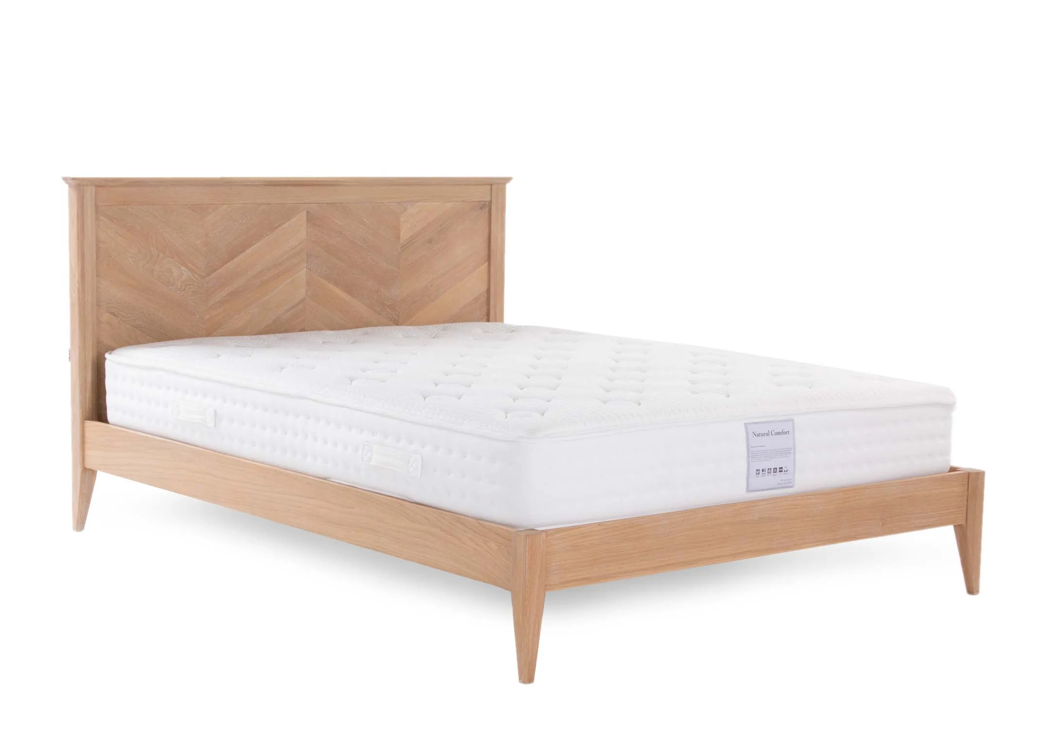 A chevron wood bedframe with a mattress from EZ Living Furniture's Chevron range. Angled view of the bed's herringbone patter