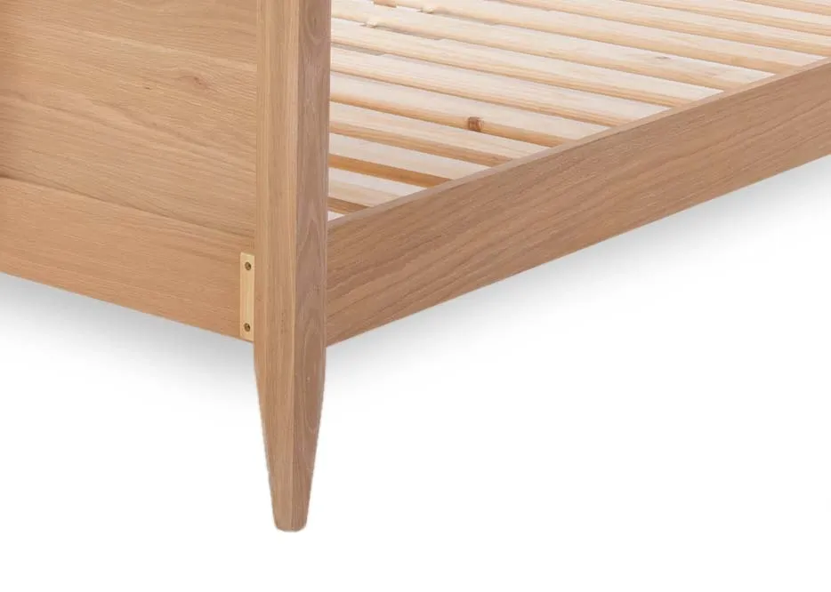 A chevron wood bedframe with a mattress from EZ Living Furniture's Chevron range. Side view of wood feet