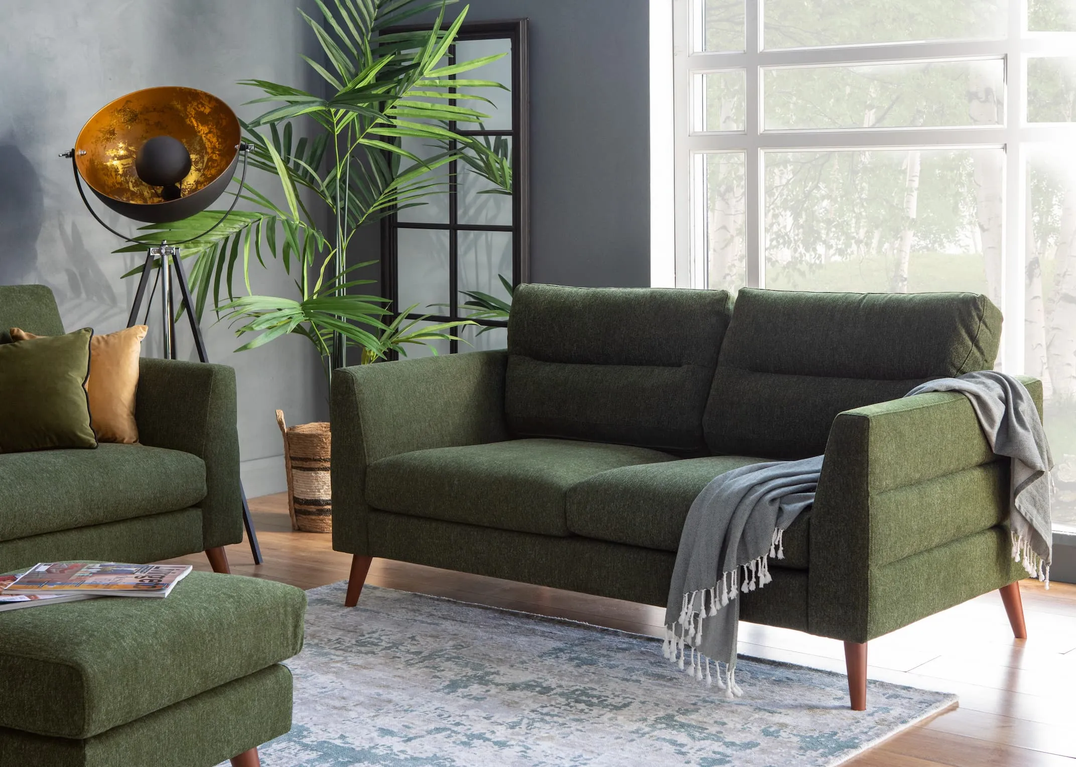 A lifestyle image of the Presley Green Sofa range with rectangular mirror & cosmos lamp