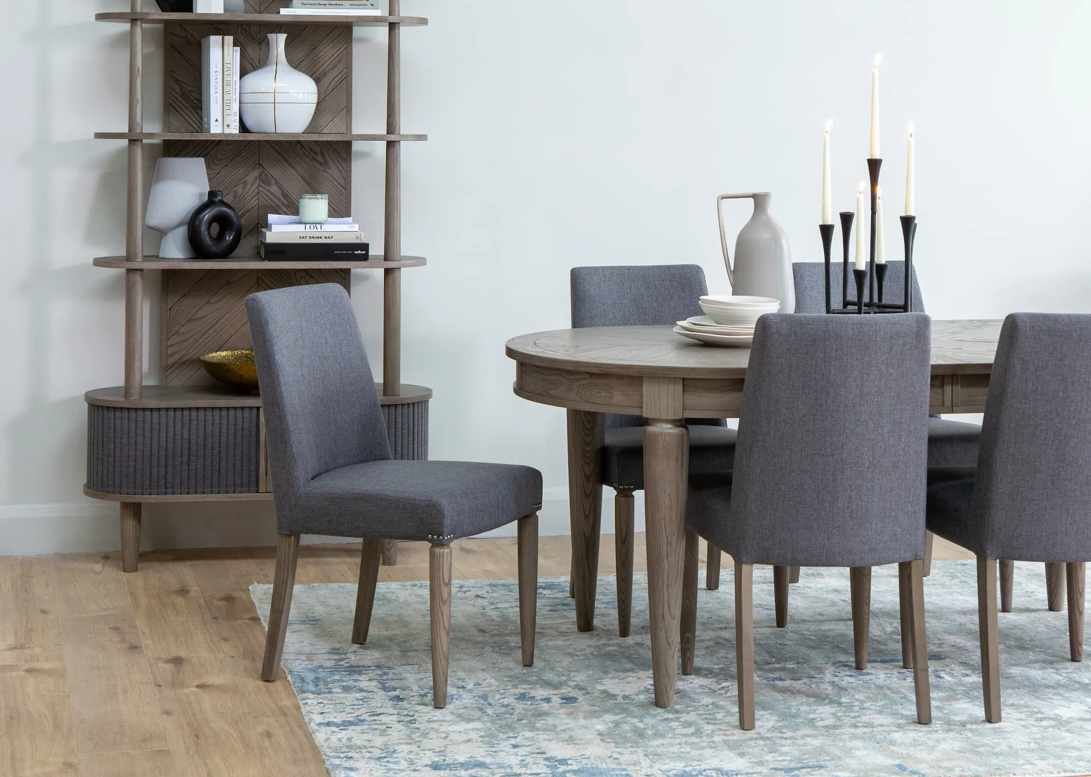 A lifestyle image of the Monroe dining table & chairs range with display unit & accessories from EZ Living.