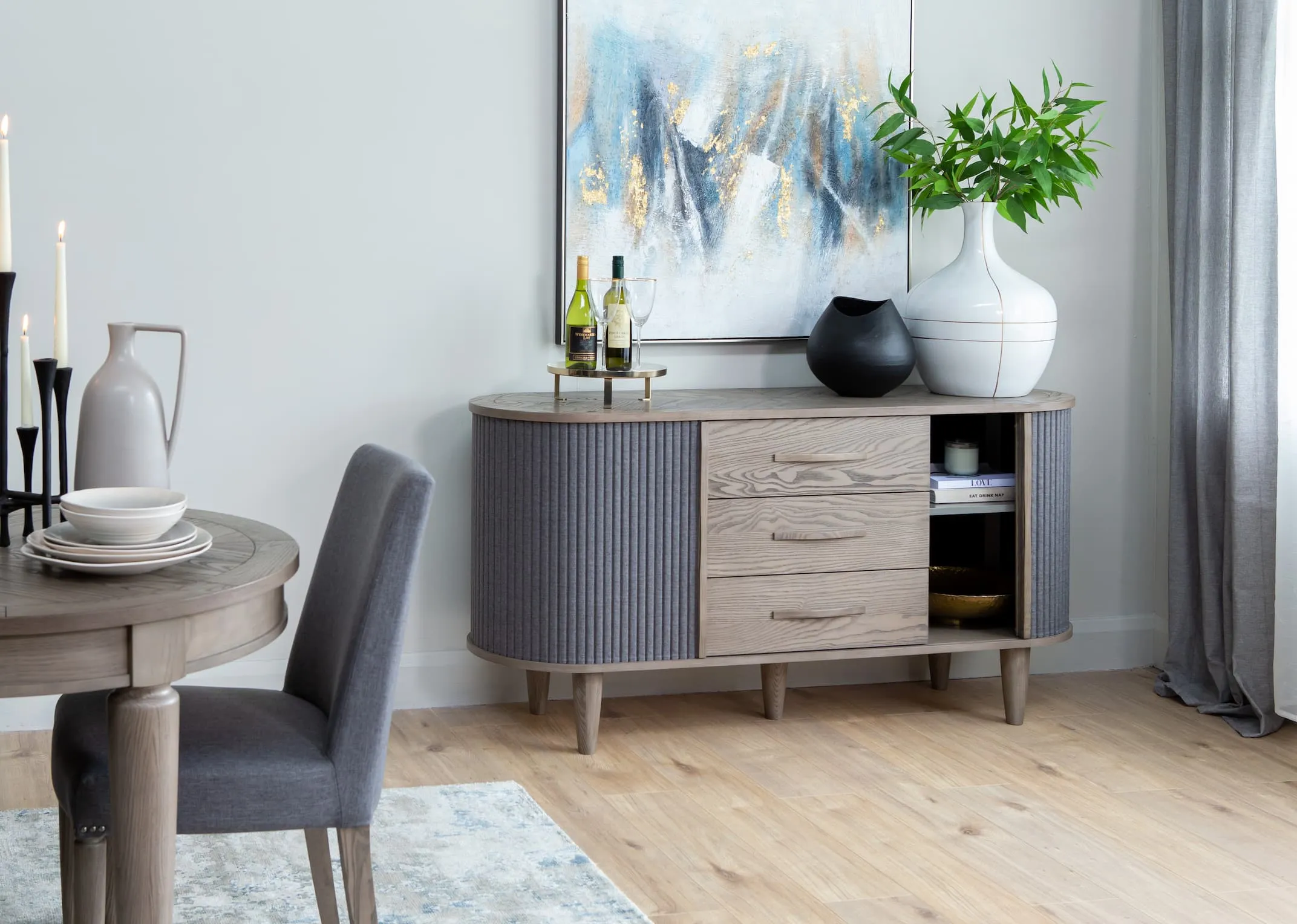 A lifestyle image of the Monroe large sideboard with dining table & Suus & breston vases