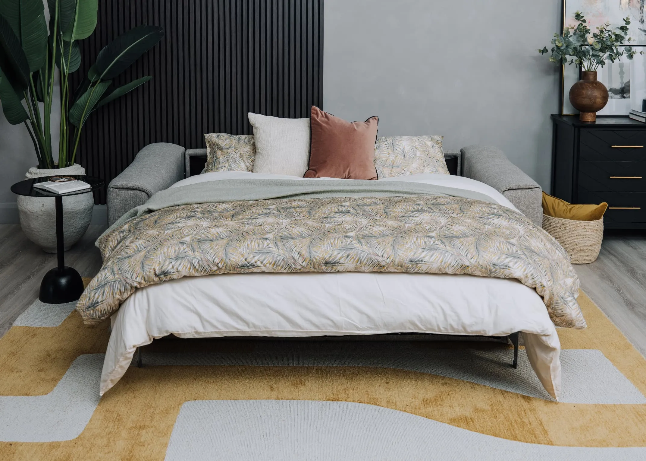 A lifestyle image of the Murano sofabed with duvet cover and pillows with Chace Rug.