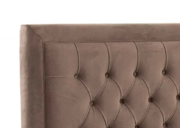 A taupe velvet ottoman bed with tufted high headboard from EZ Livings Majestic range. Side view of thick headboard