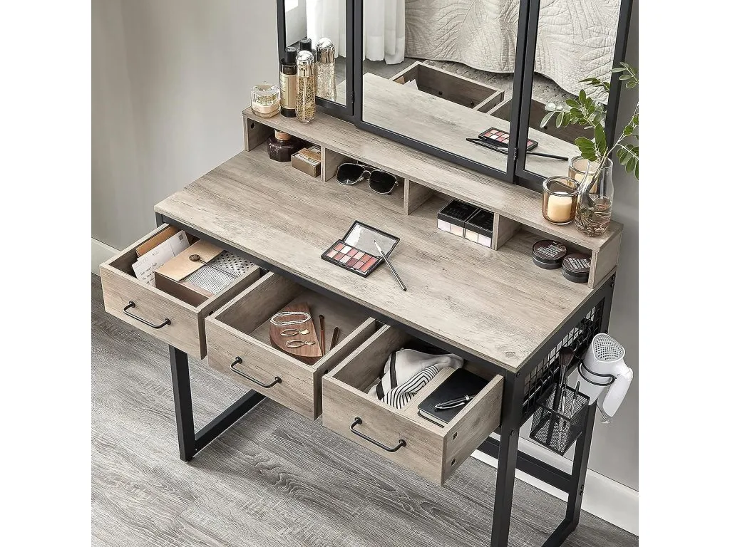 A lifestyle image of the Orwell grey dressing tabale with drawers open revealing space for jewellery & cosmetics.