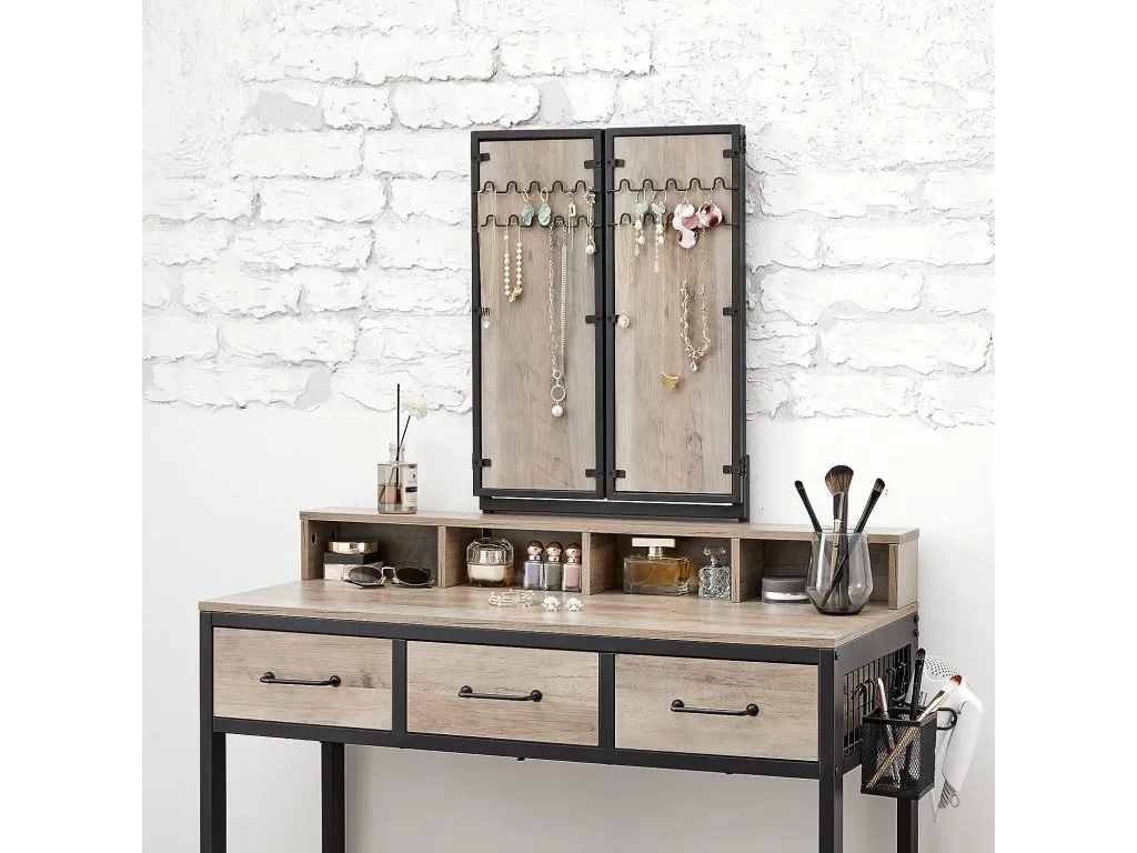 A lifestyle image of the Orwell grey dressing table with mirror closed showing hanging hooks on the back for jewellery.