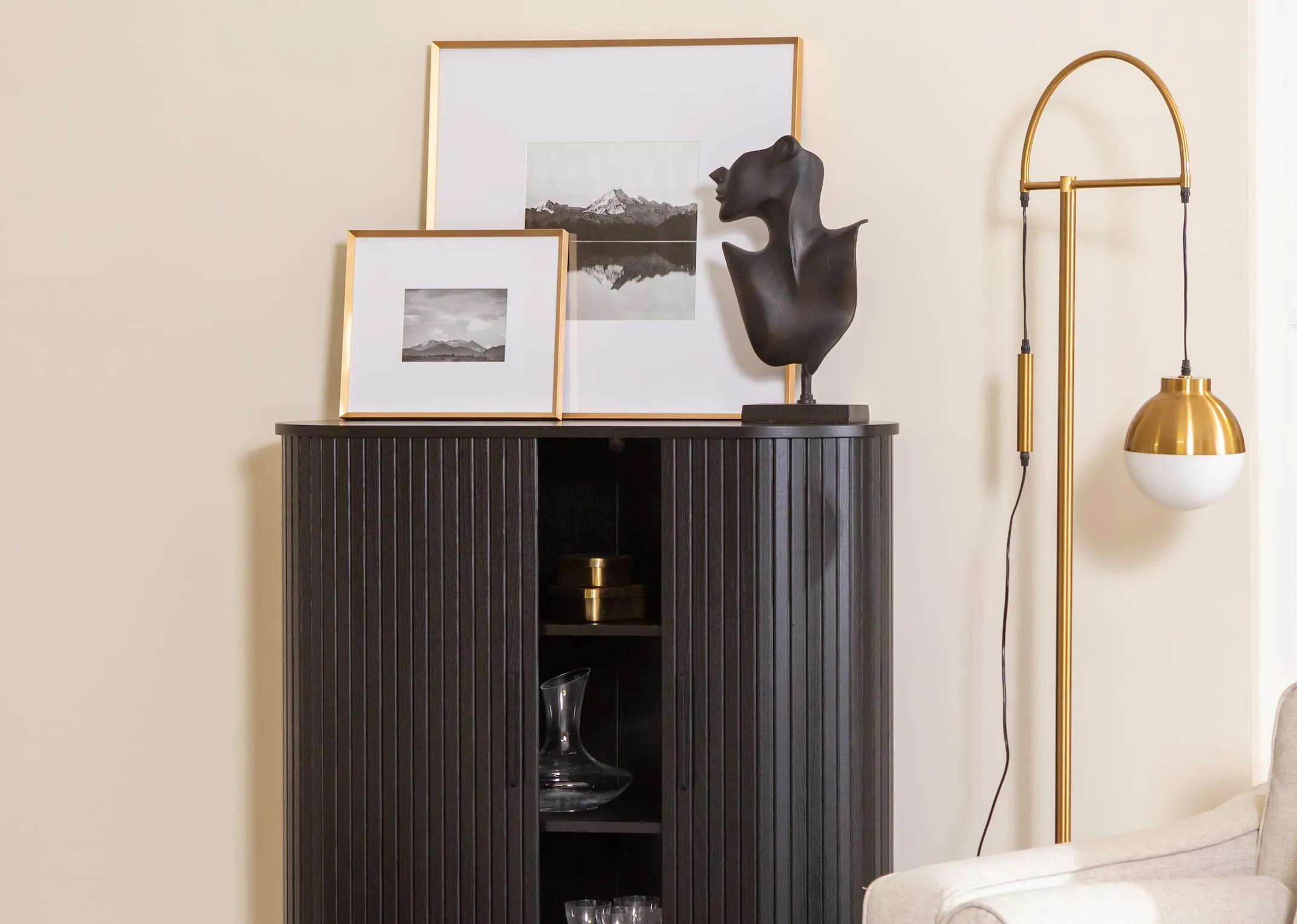 A lifestyle image of the Arabel brass photo frame on the Nola sideboard with Casper lamp.