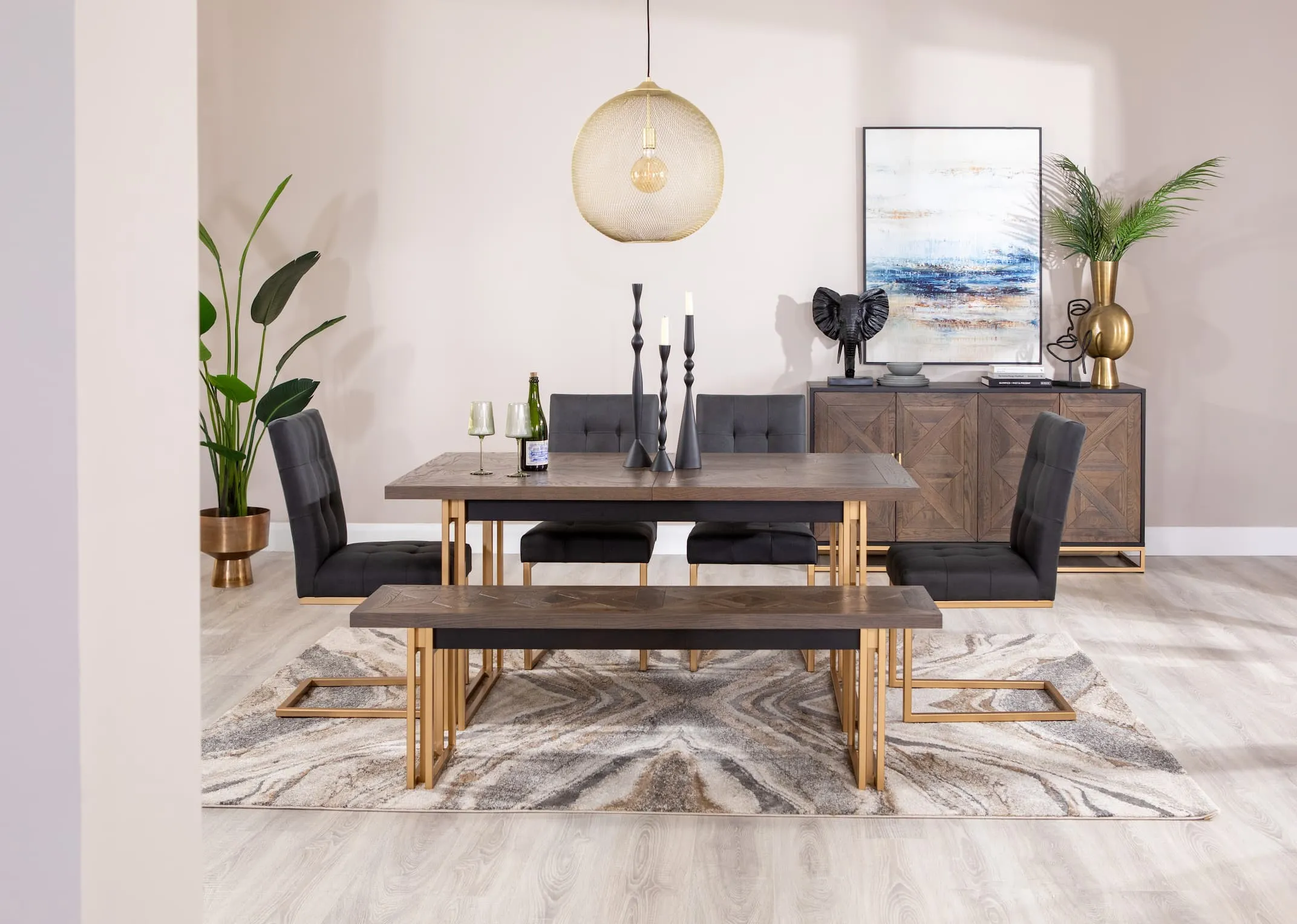 A lifestyle image of the Greenwich smaller Greenwich dining table without extension with chairs & bench with sideboard and Pasha rug
