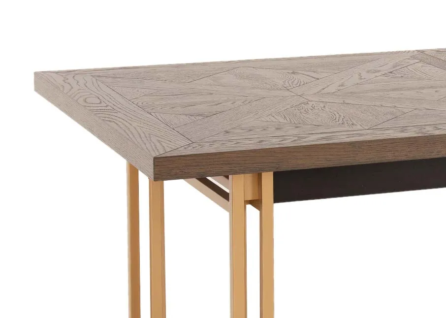 A gold metal framed dining table with dark wood top from EZ Livings Greenwich range. Closeup of herrungbone wood top