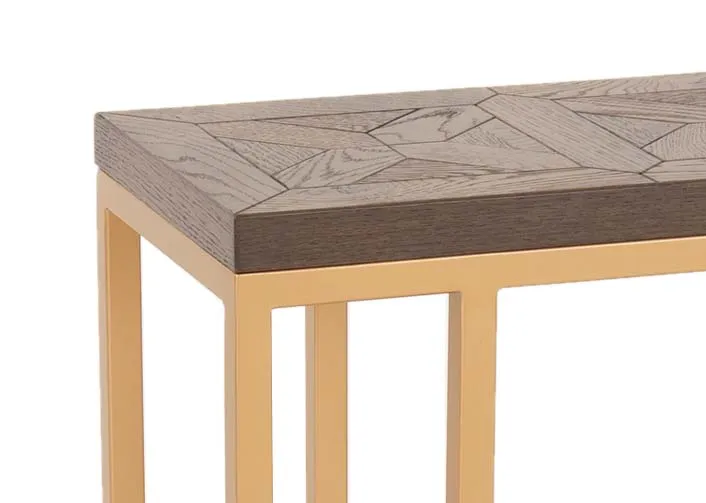 A gold metal framed sofa table with dark wood top from EZ Livings Greenwich range. Closeup of carved chevro