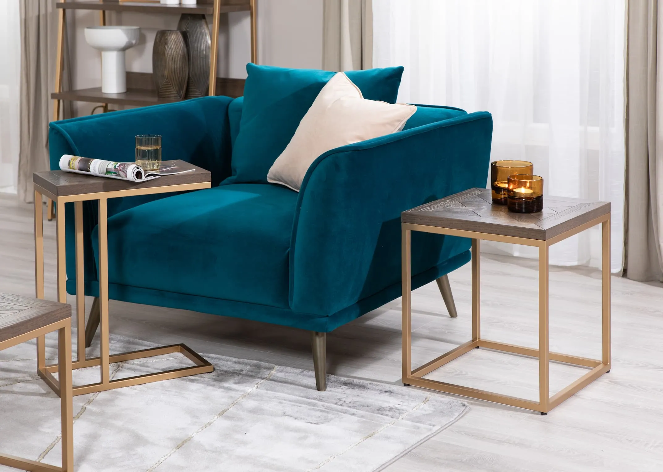 A lifestyle image of the Katie Teal Cuddler with lamp table & sofa table.
