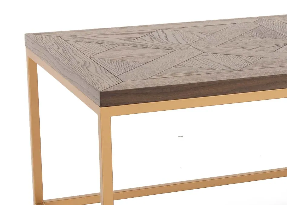 A gold metal framed coffee table with dark wood top from EZ Livings Greenwich range. Closeup of dark engraved wood top