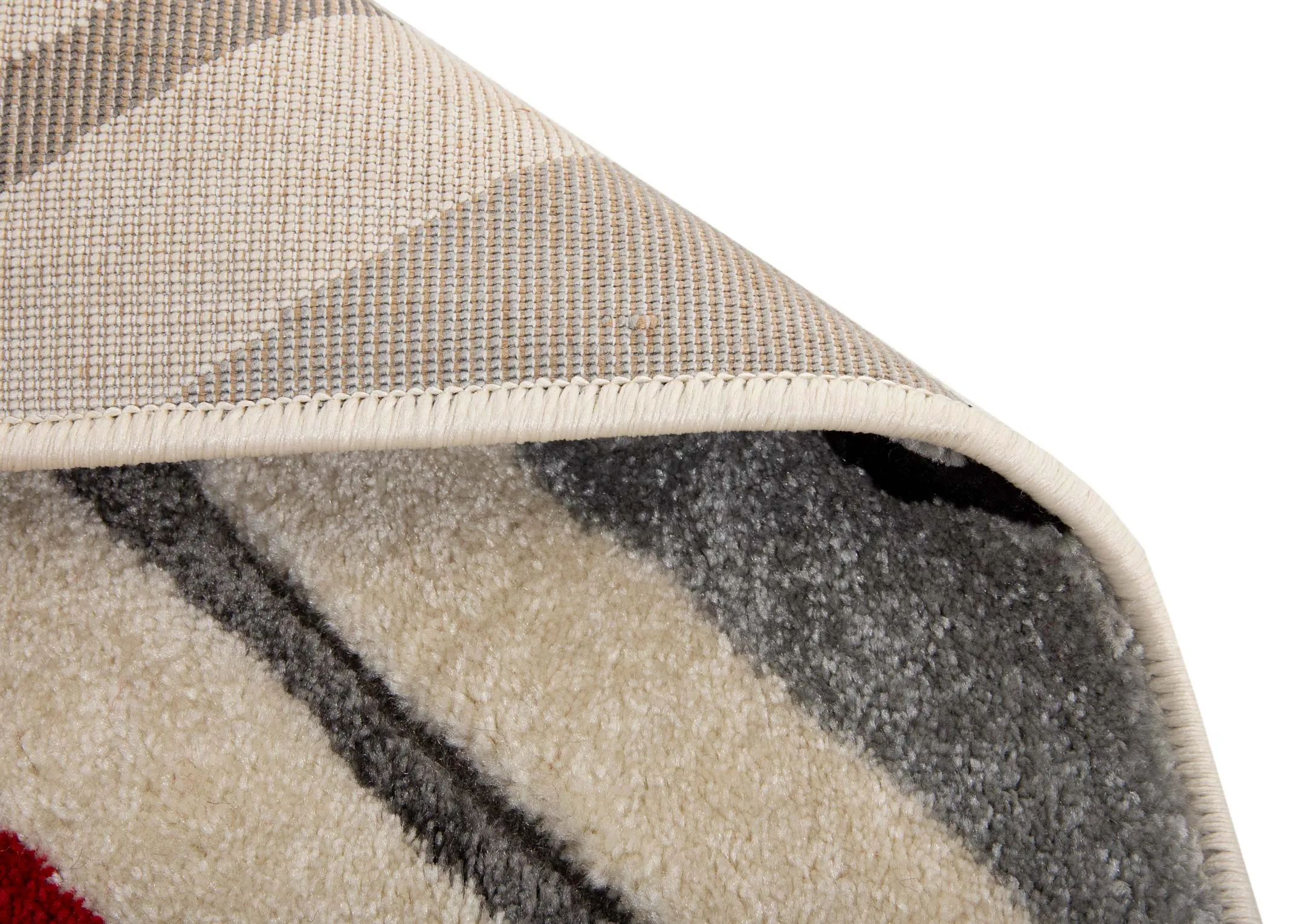 A cream rug with grey and deep red octagon pattern design from EZ Livings Forma range. Closeup of underlay