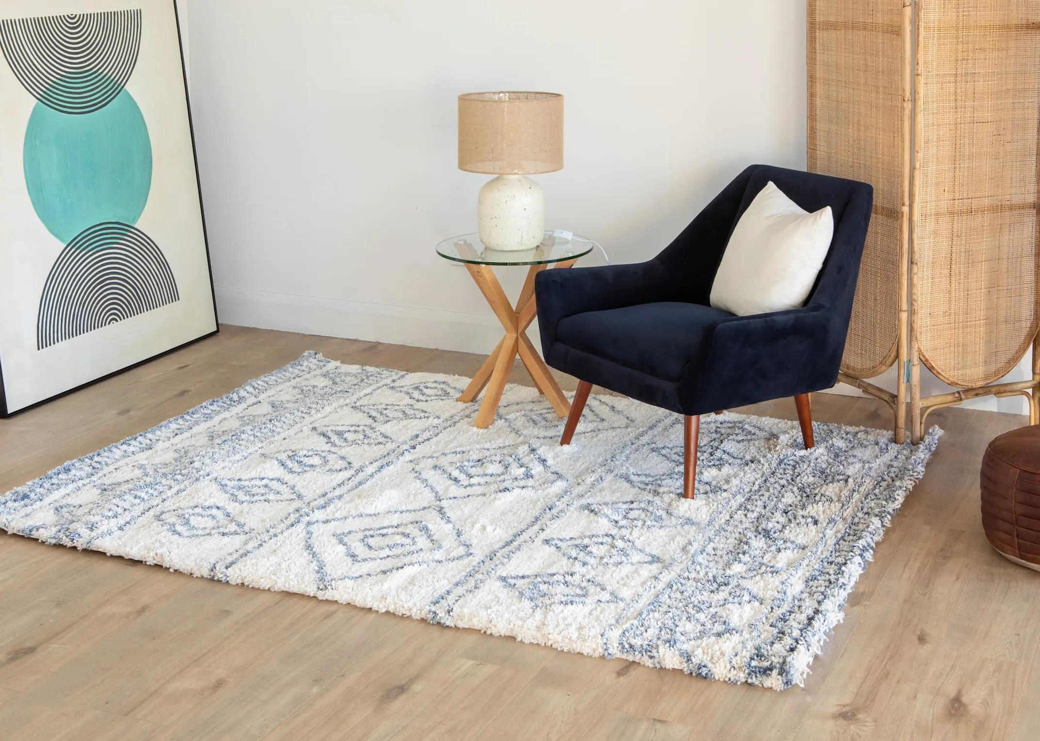 A lifestyle image of the Janey Navy chair with the Sula white & blue rug with Heaven table and Renzo lamp.