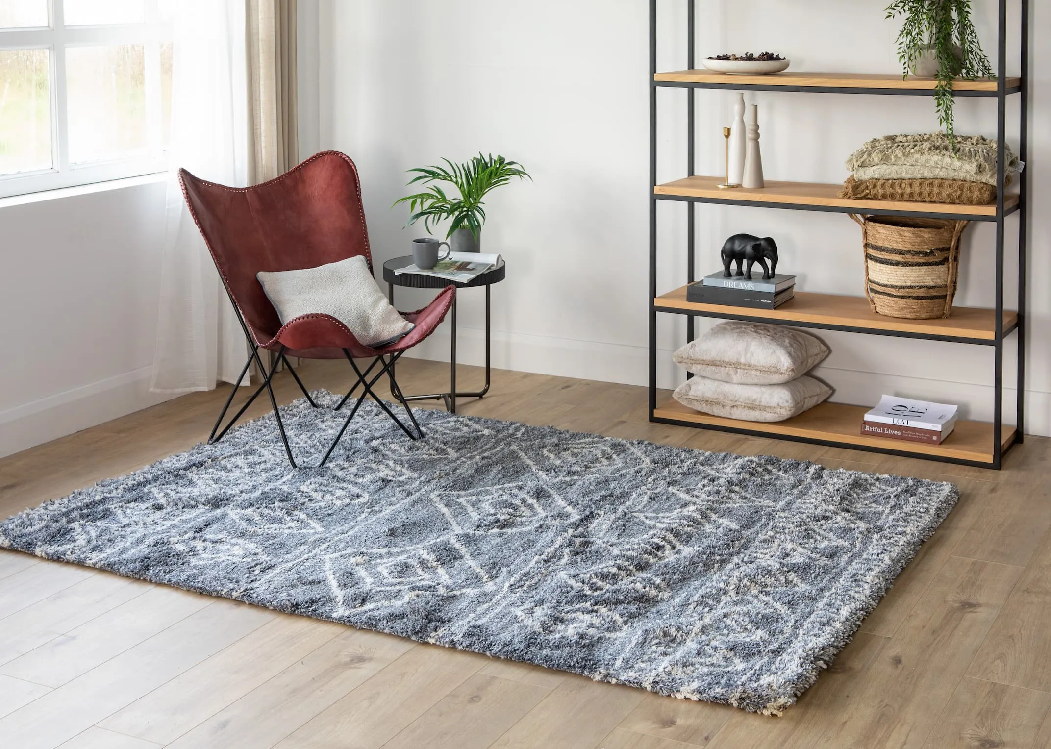 A lifestyle image of the Ranger relax chair with the Mila bookcase and Sula grey rug