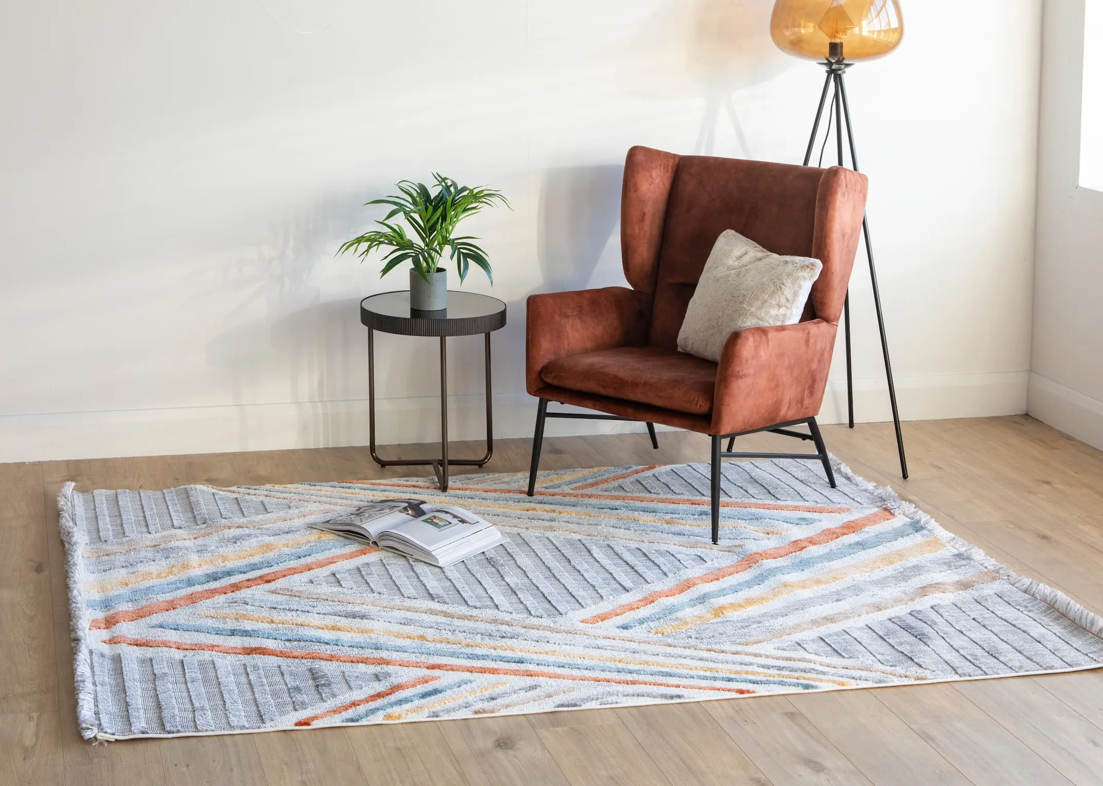 A lifestyle image of the Boston chair with Gatsby rug with mady side table