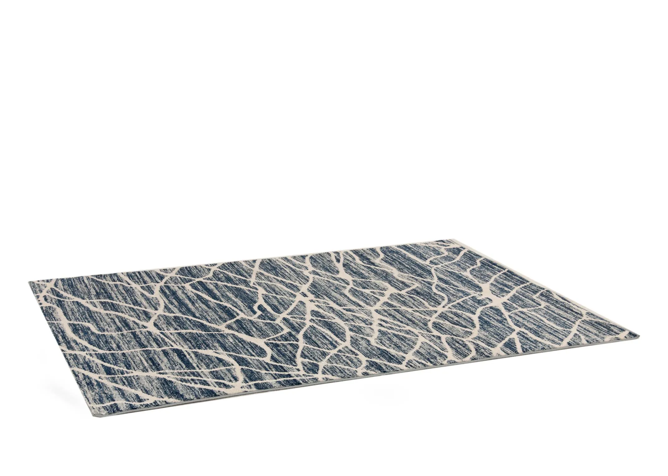 A navy blue rug with cream cracked pattern from EZ Livings Grotto range. Angled view of short pile rug