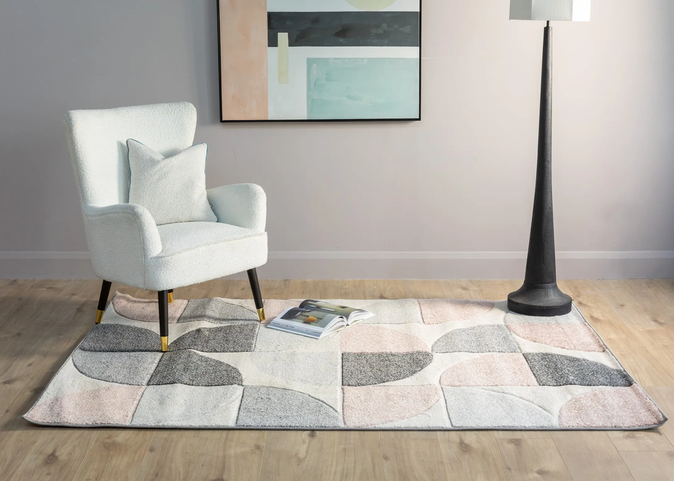 A lifestyle image of the Holden pink rug with Shoraz armchair and Pastel canvas with Jovany floor lamp