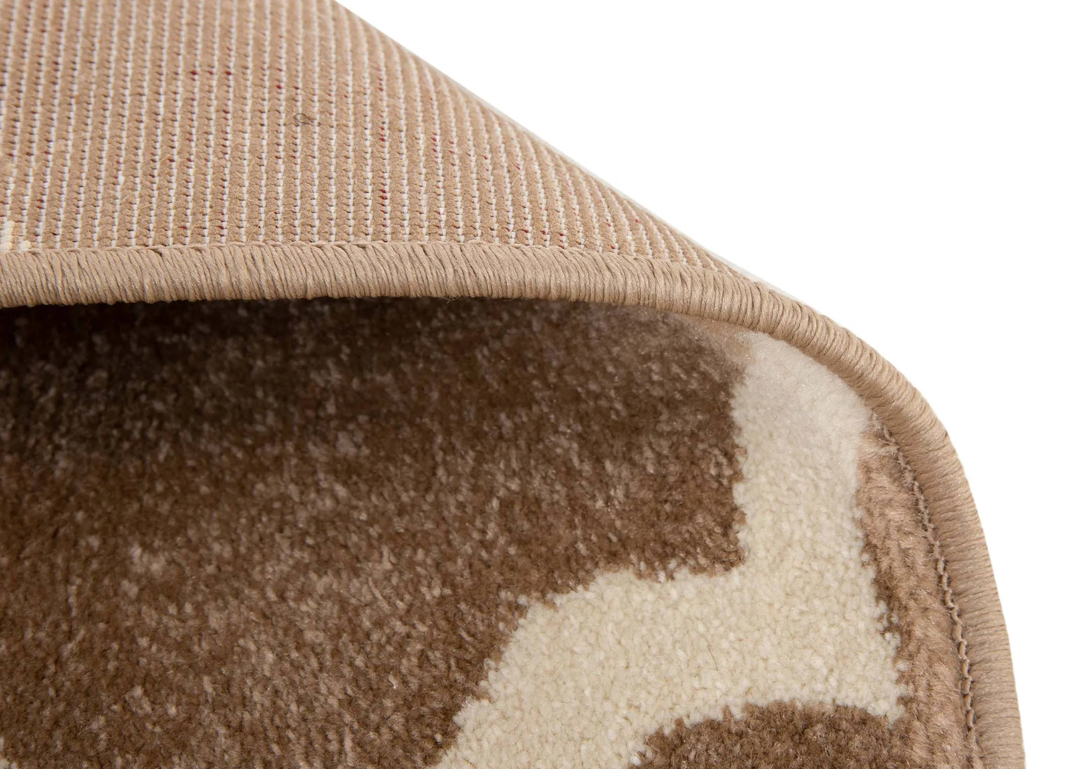 A dark beige rug with cream trellis design from EZ Livings Delia range. Closeup of underlay