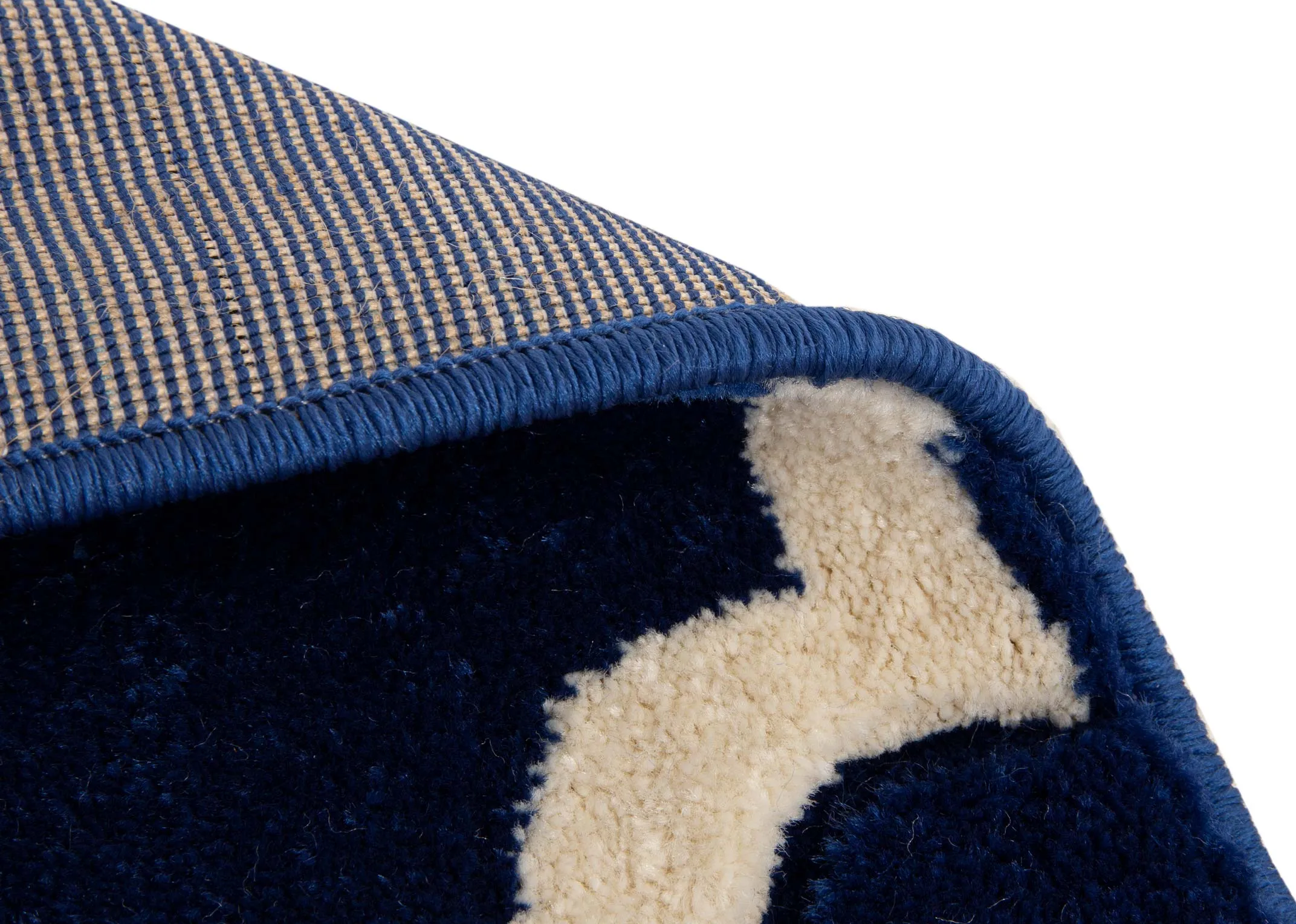 A navy blue rug with cream trellis design from EZ Livings Delia range. Closeup of underlay