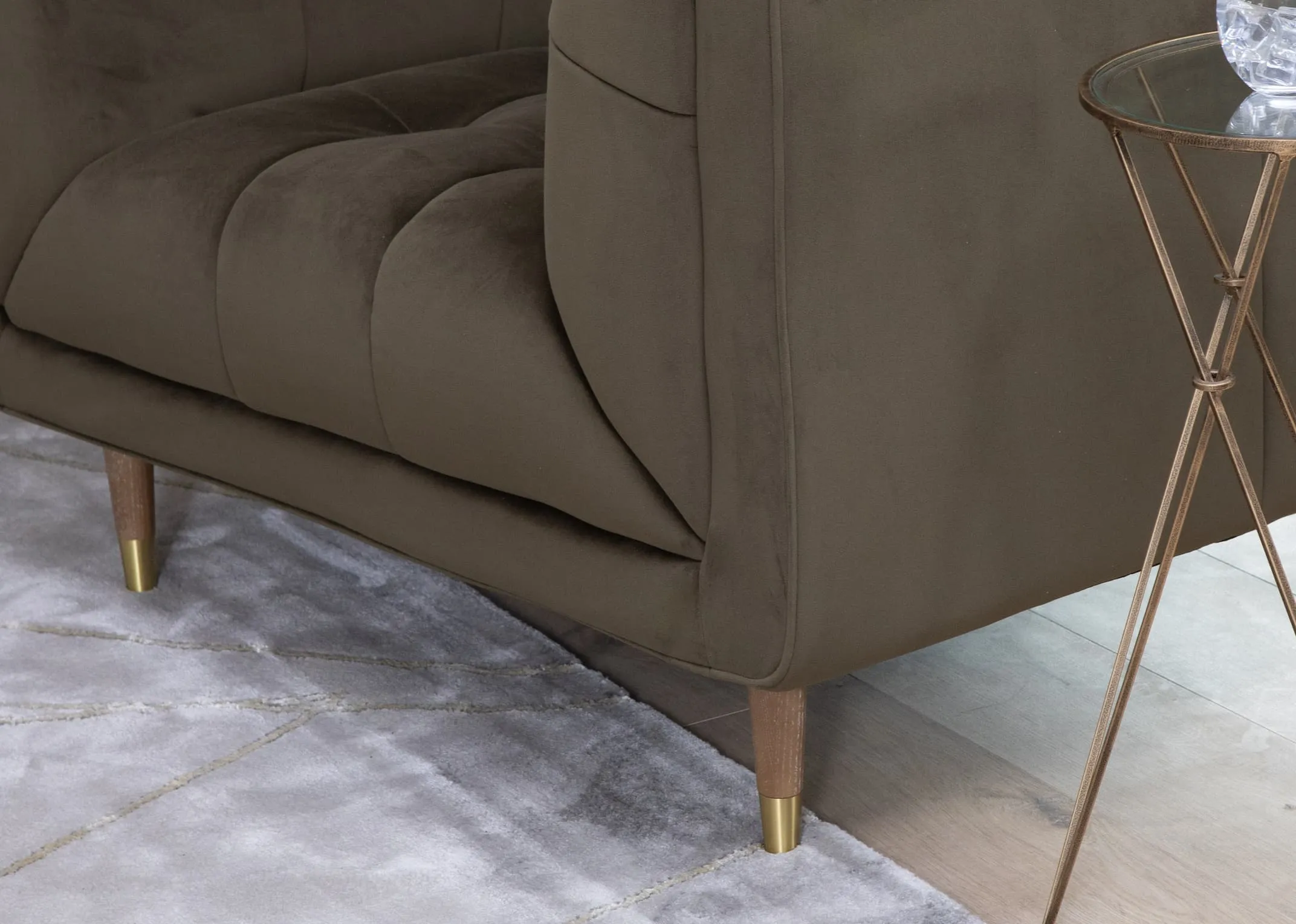 A lifestyle image of the Grace green velvet sofa with a closeup detail shot of the oak & gold feet.