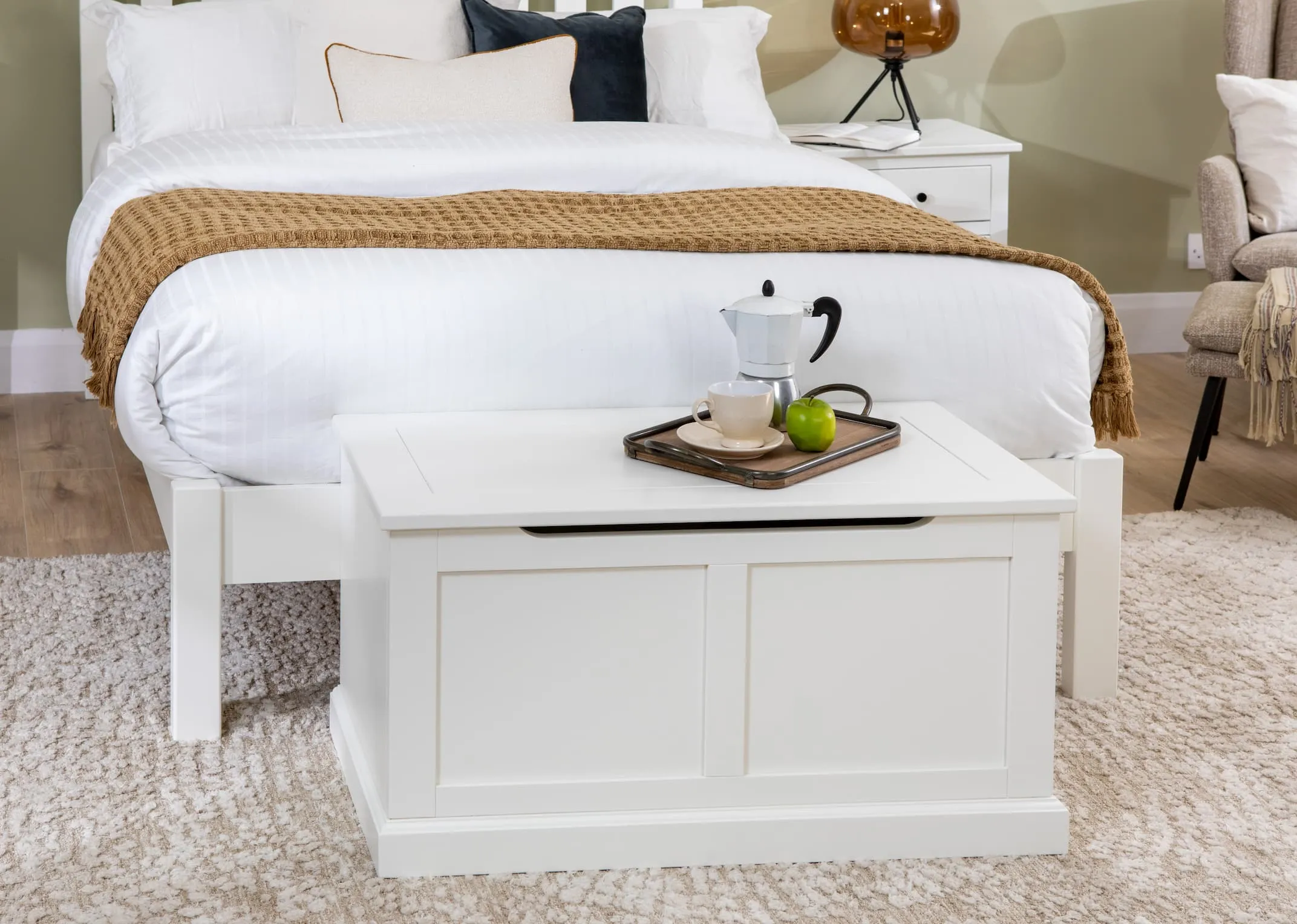 A lifestyle image of the White Atlas bedroom range including bedframe & blanket box closed with tray on top