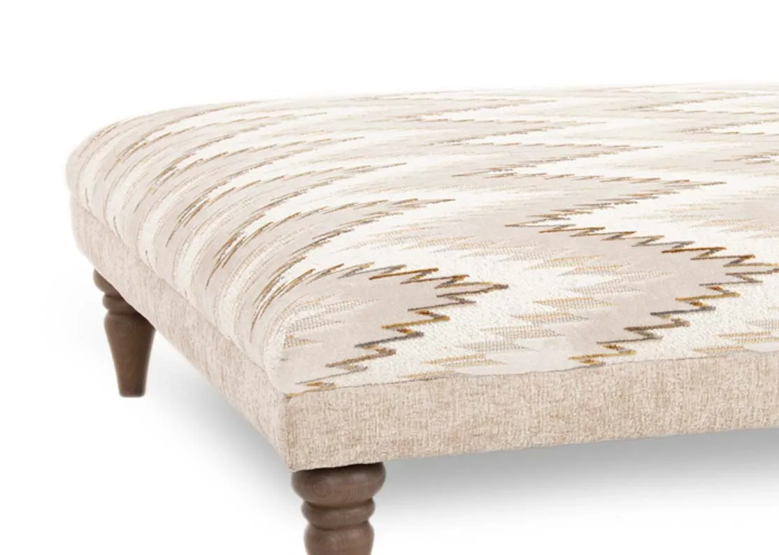 A square accent footstool from EZ Livings Hayden range. Closeup of oak feet