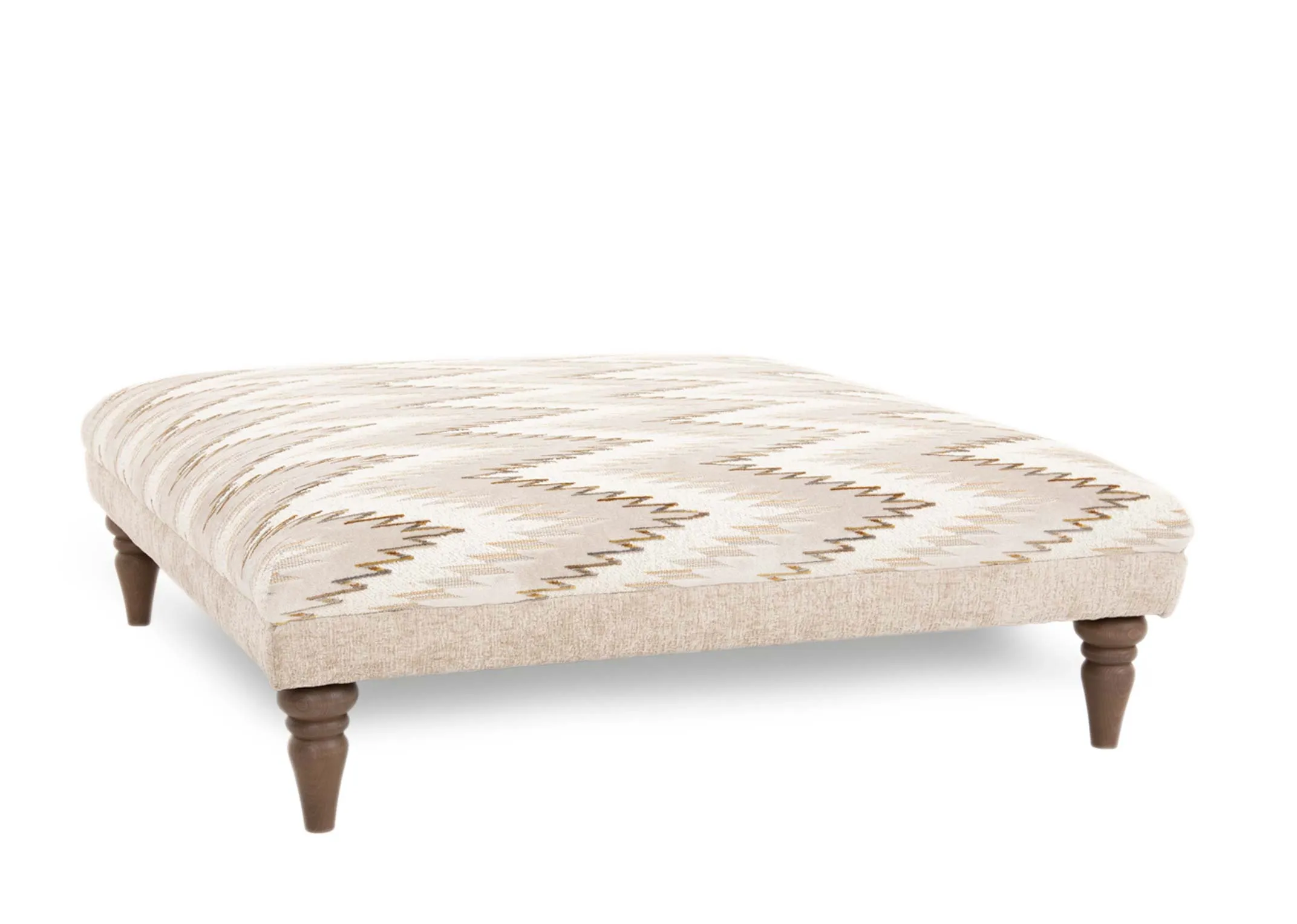 A square accent footstool from EZ Livings Hayden range. Angled view of taupe & gold aztec pattern.