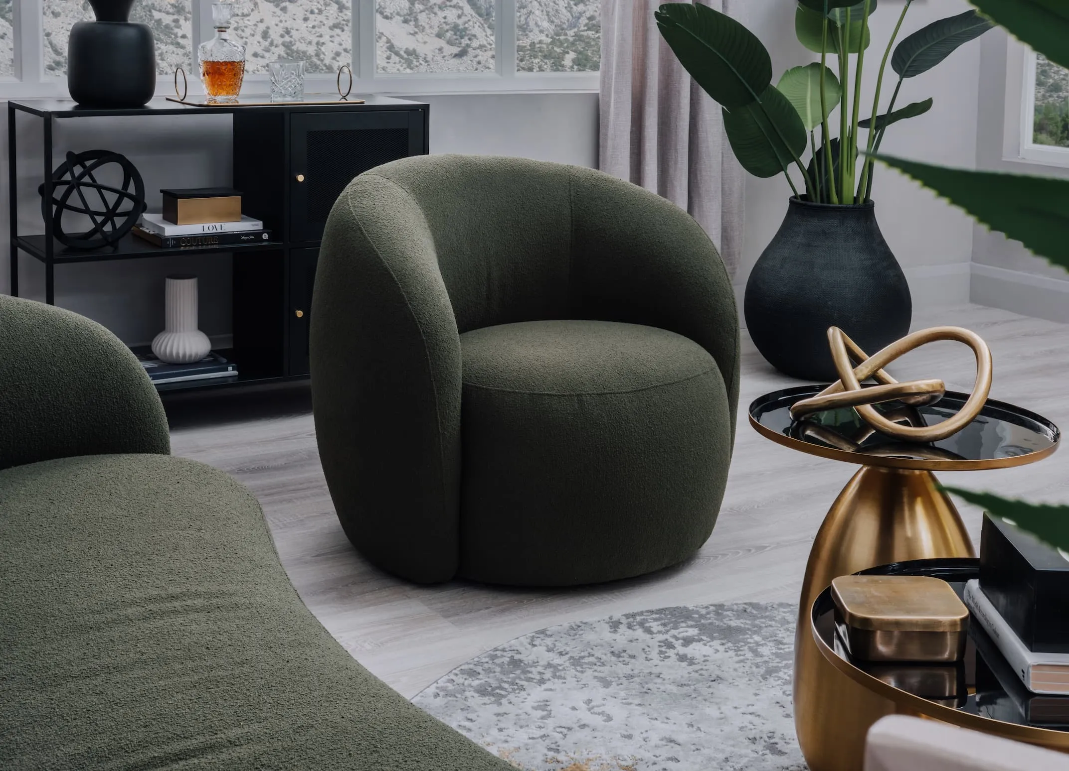 A lifestyle image of the Florance green chair with ritz rug and carmel sideboard.