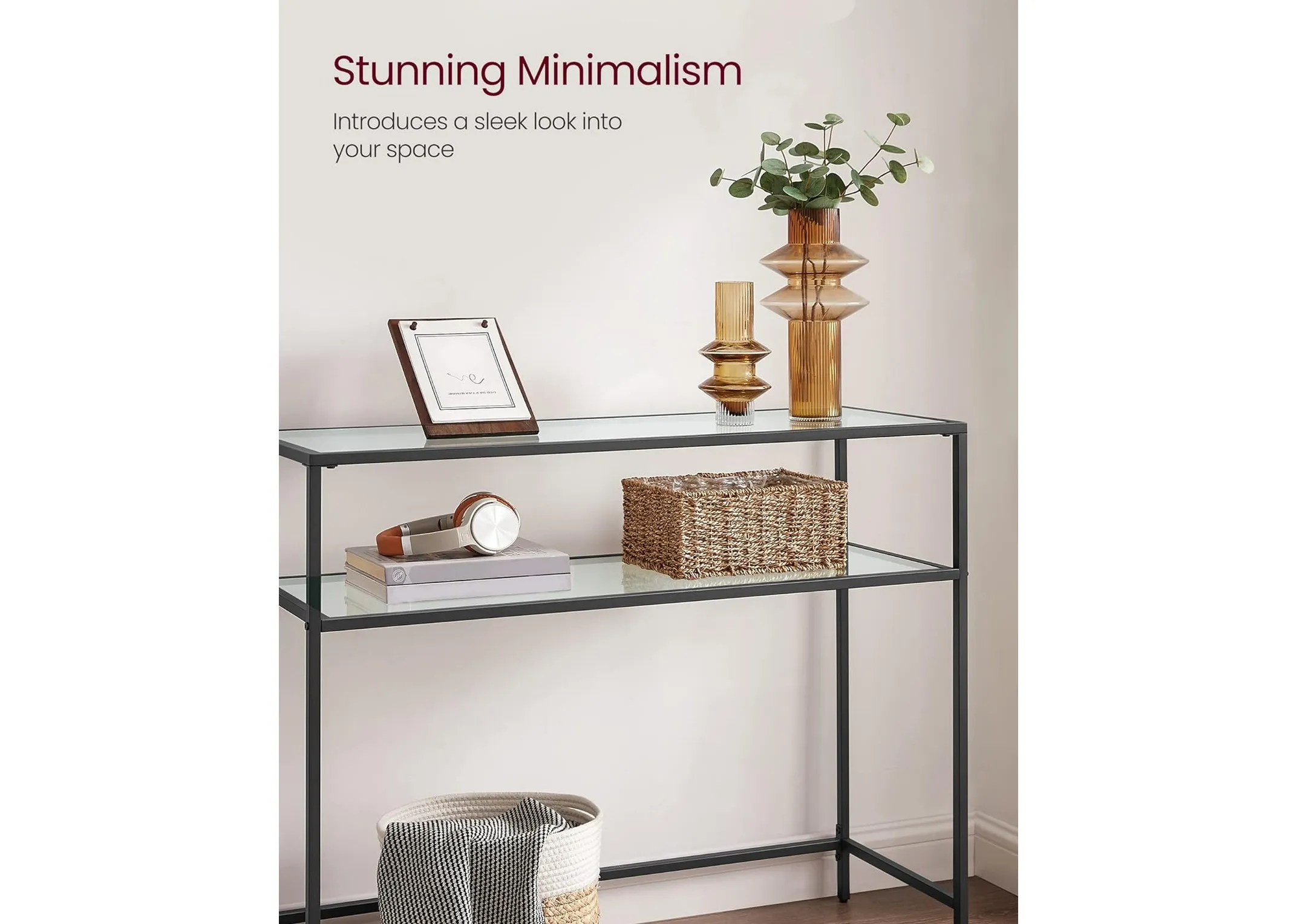 A black metal console table with glass shelves from EZ Livings Zafon range. Angled view of shelves with vases and frames