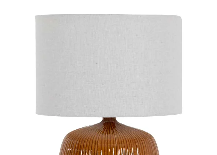 A glossy brown table lamp with white shade from EZ Livings Bann range. Closeup of large white drum shade.