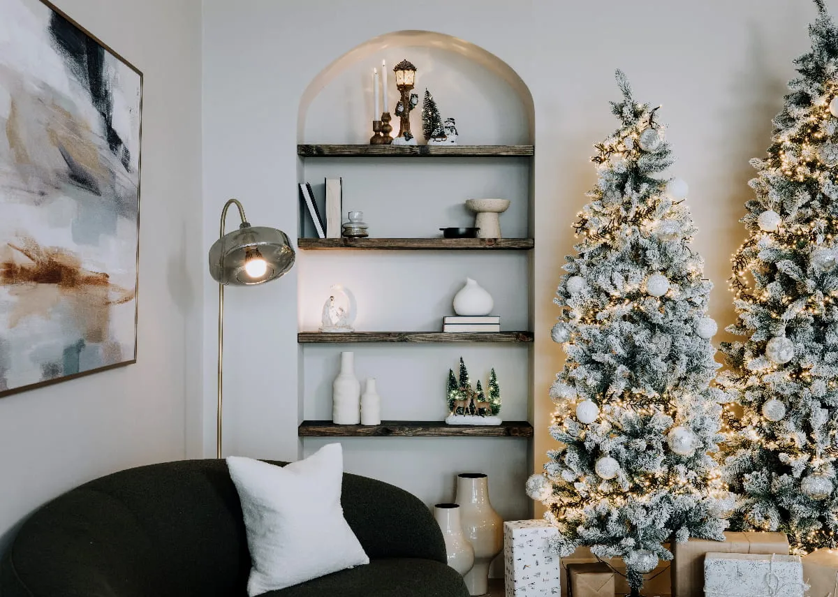 A lifestyle image of an alcove decorated with Christmas ornaments and vases with Florence sofa and Noble christmas trees.